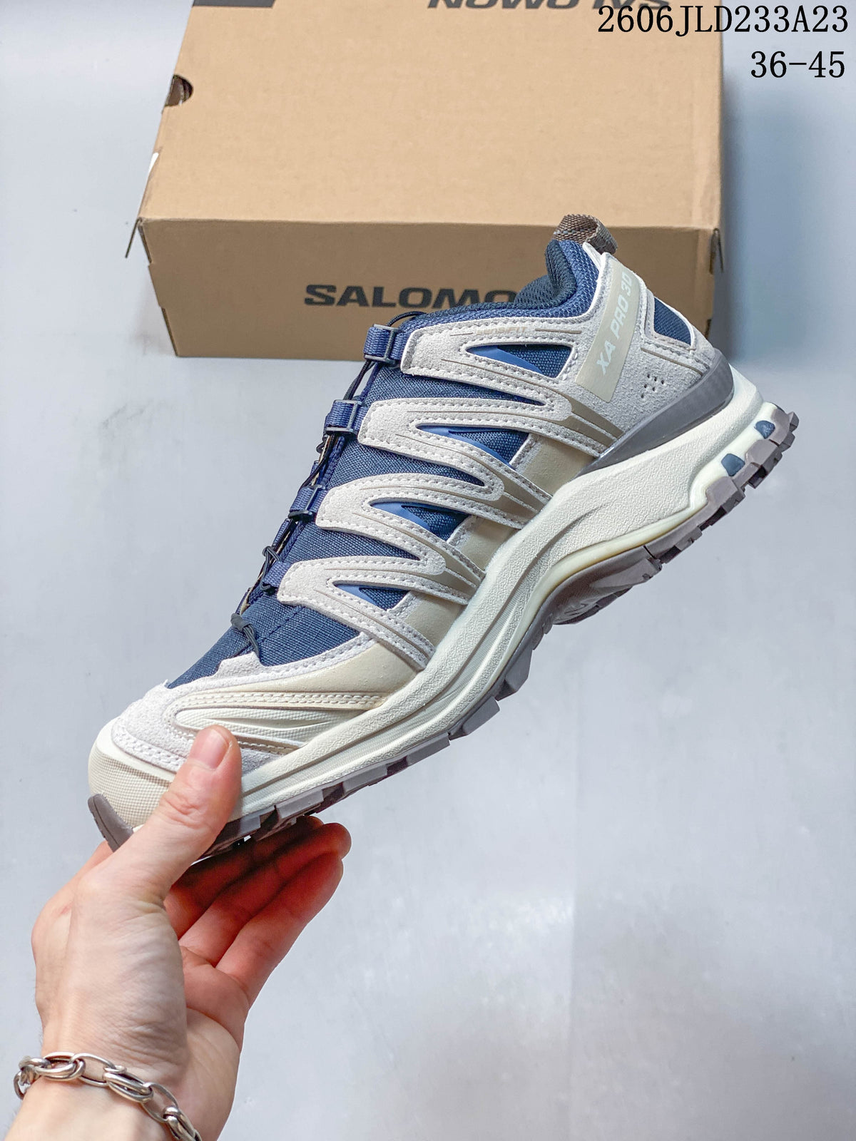 Side view of the Salomon XA Pro 3D Suede shoe with blue upper and light neutral overlays