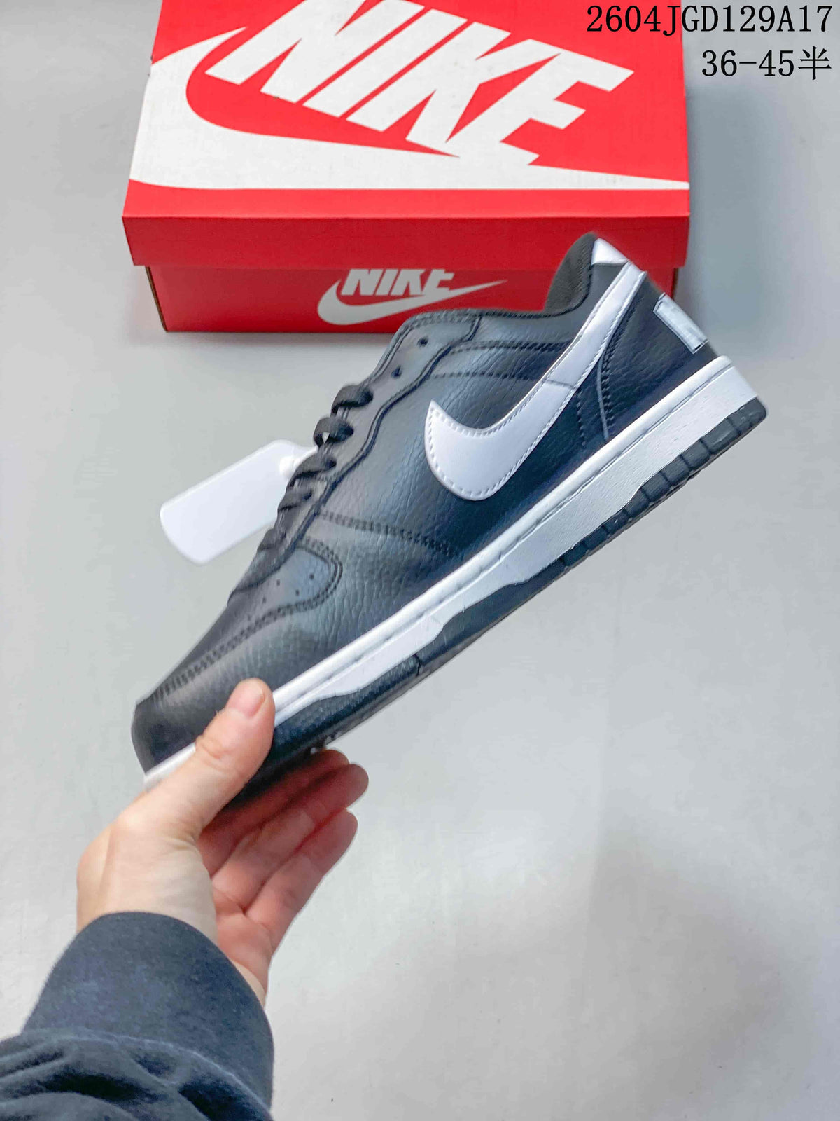 Side view of the navy low-top sneaker with a white Swoosh and white midsole