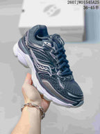 Angled side view of the Saucony ProGrid Omni 9 sneaker showing the dark upper, reflective-looking overlays and white sole.