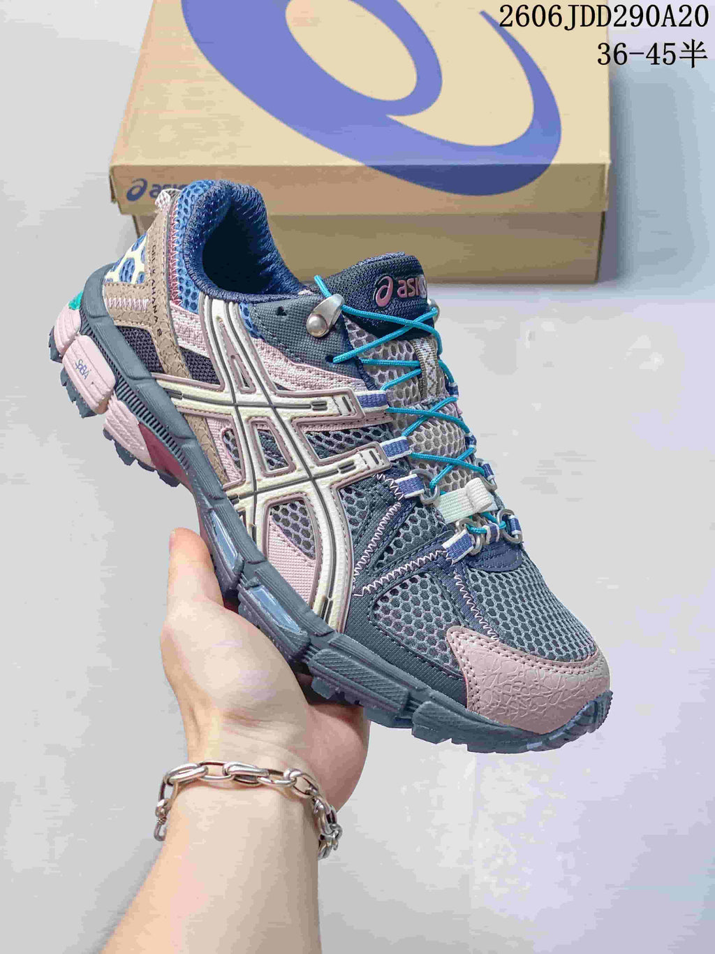Angled side view of the gray, navy and pink ASICS Tiger Gel-Kahana 8 sneaker with a rugged outsole.