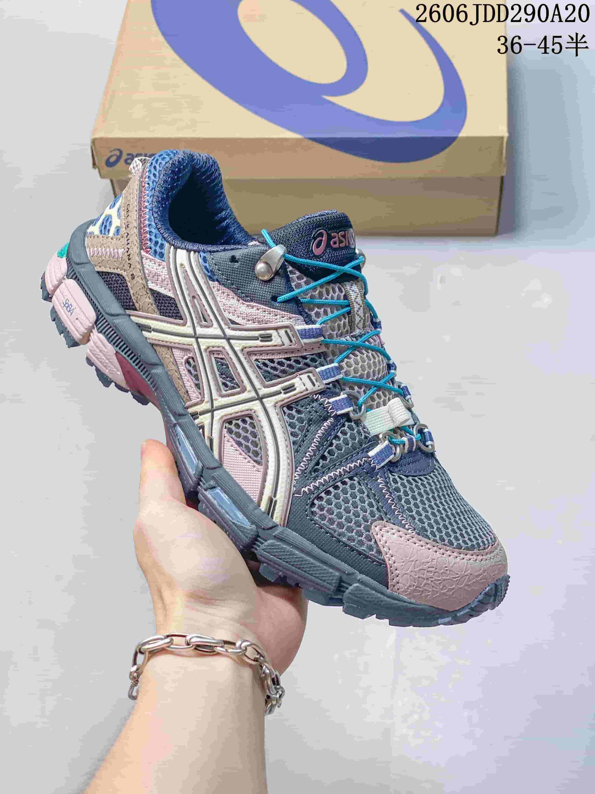 Angled side view of the gray, navy and pink ASICS Tiger Gel-Kahana 8 sneaker with a rugged outsole.