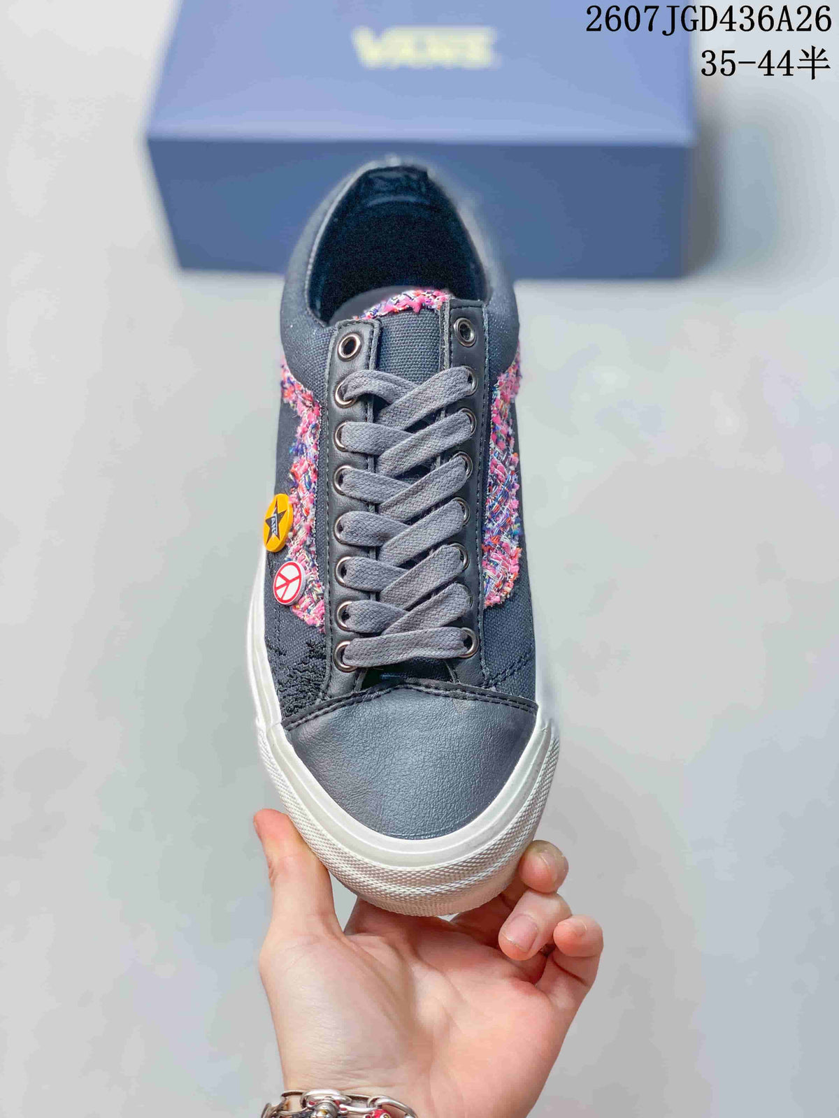 Top view showing gray laces, metal eyelets, dark navy panels and multicolor side detailing.