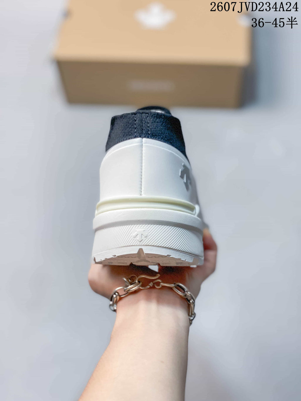 Rear view showing the white heel structure and navy collar.