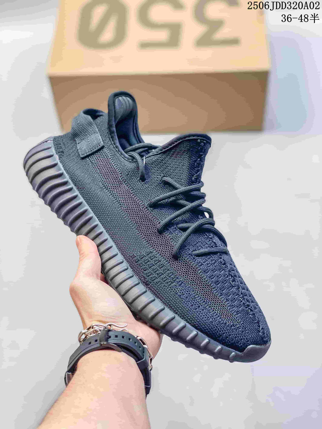 Dark gray and black knit sneaker with a subtle contrasting side stripe, dark laces, and a ribbed sole.
