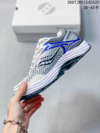 Side view of the sneaker showing the mesh-look upper, Saucony side branding and blue outsole accents.