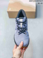 Top-down view of the sneaker showing the lavender-grey upper, black laces, padded tongue, and Cloud X label.