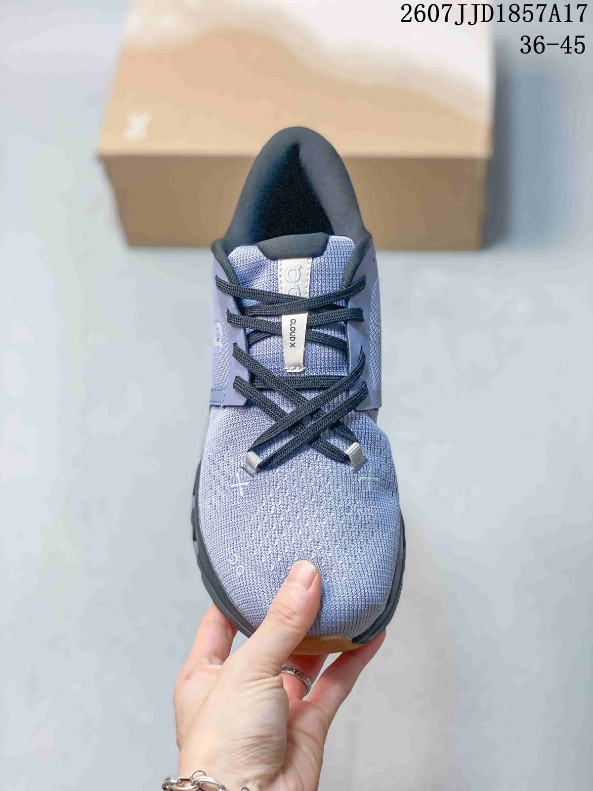 Top-down view of the sneaker showing the lavender-grey upper, black laces, padded tongue, and Cloud X label.