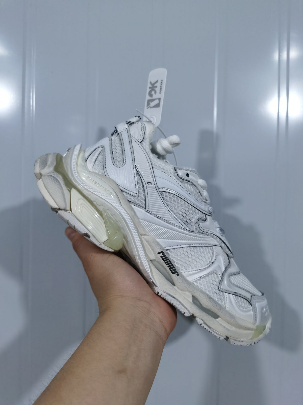 Reverse-side view of the white PUMA sneaker showing the layered upper, textured mesh, and side branding.