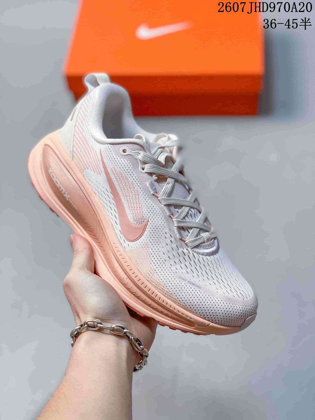White Nike Structure Plus running sneaker with soft pink accents and a pale pink midsole.