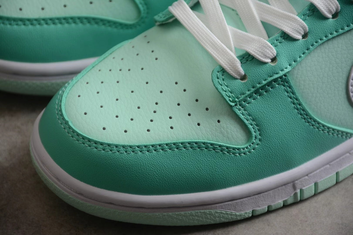 Detailed view of the perforated light mint toe box, darker mint overlays, stitching, and white laces.