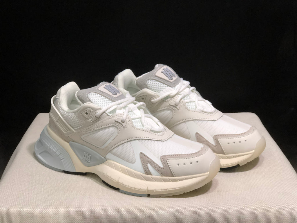 Three-quarter view of the pair highlighting the layered upper and contrasting sole details.