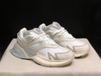 Three-quarter view of the pair highlighting the layered upper and contrasting sole details.
