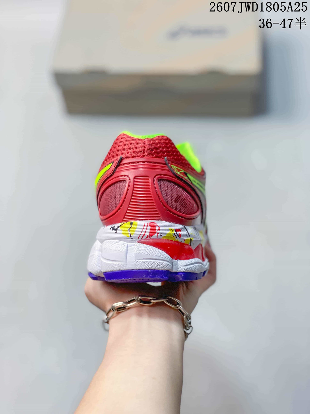 Rear view showing the red heel, green collar lining, white midsole and purple outsole.