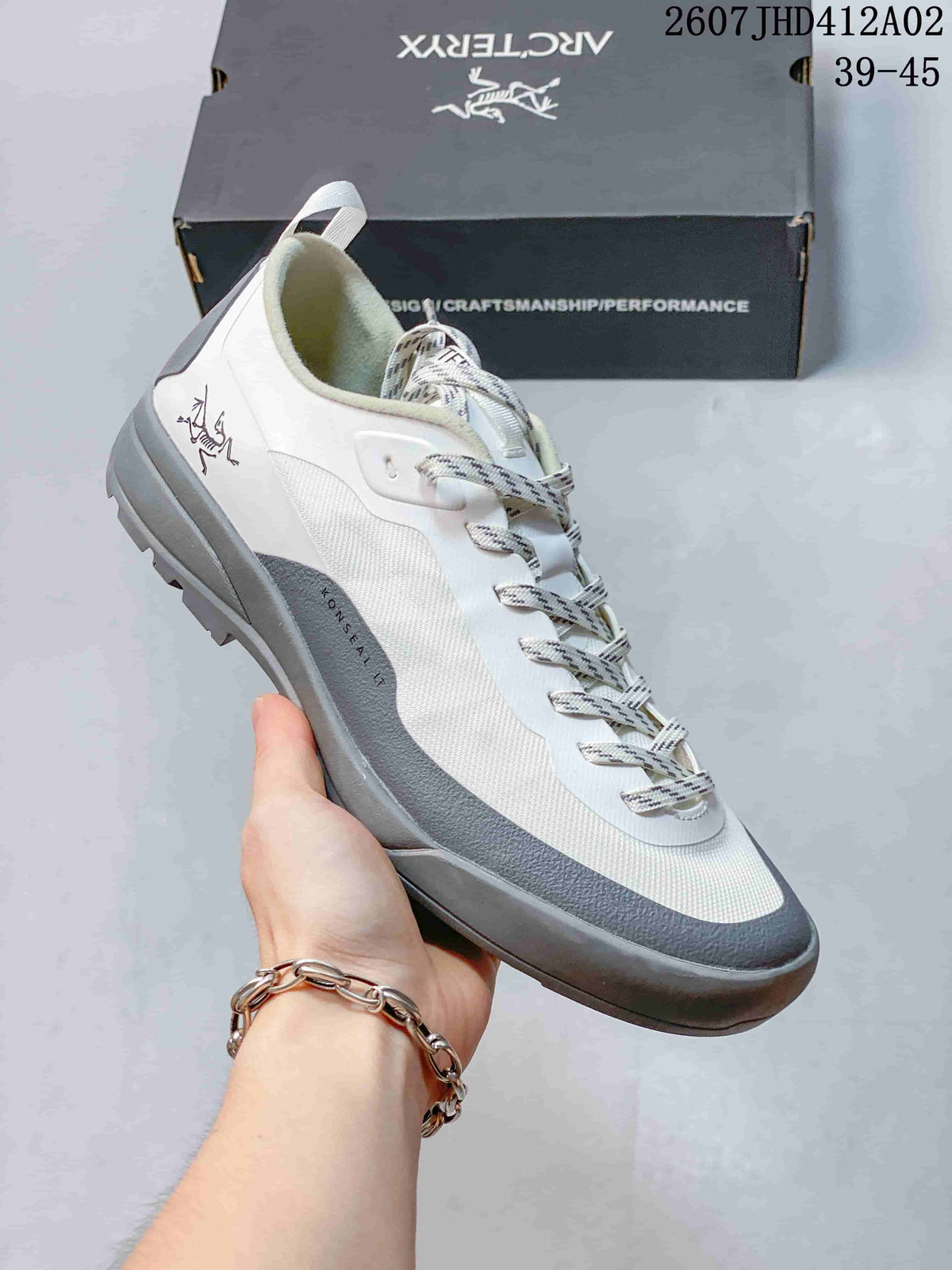 White and gray Arc'teryx Konseal LT W shoe with patterned upper and lugged outsole.