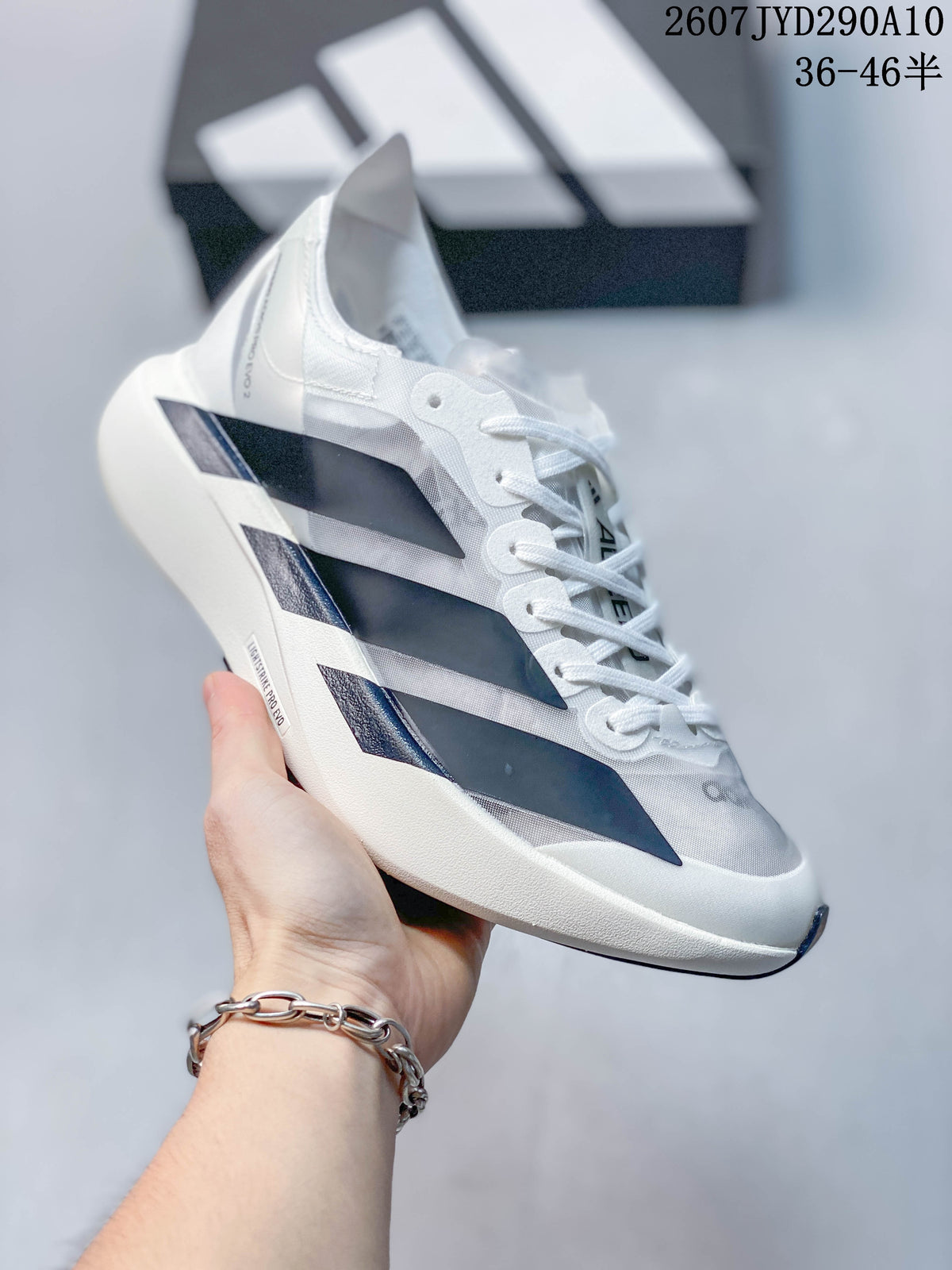 Angled side view of the Adidas Adizero Adios Pro Evo2 sneaker showing the lace-up upper, side stripes, and sculpted sole.