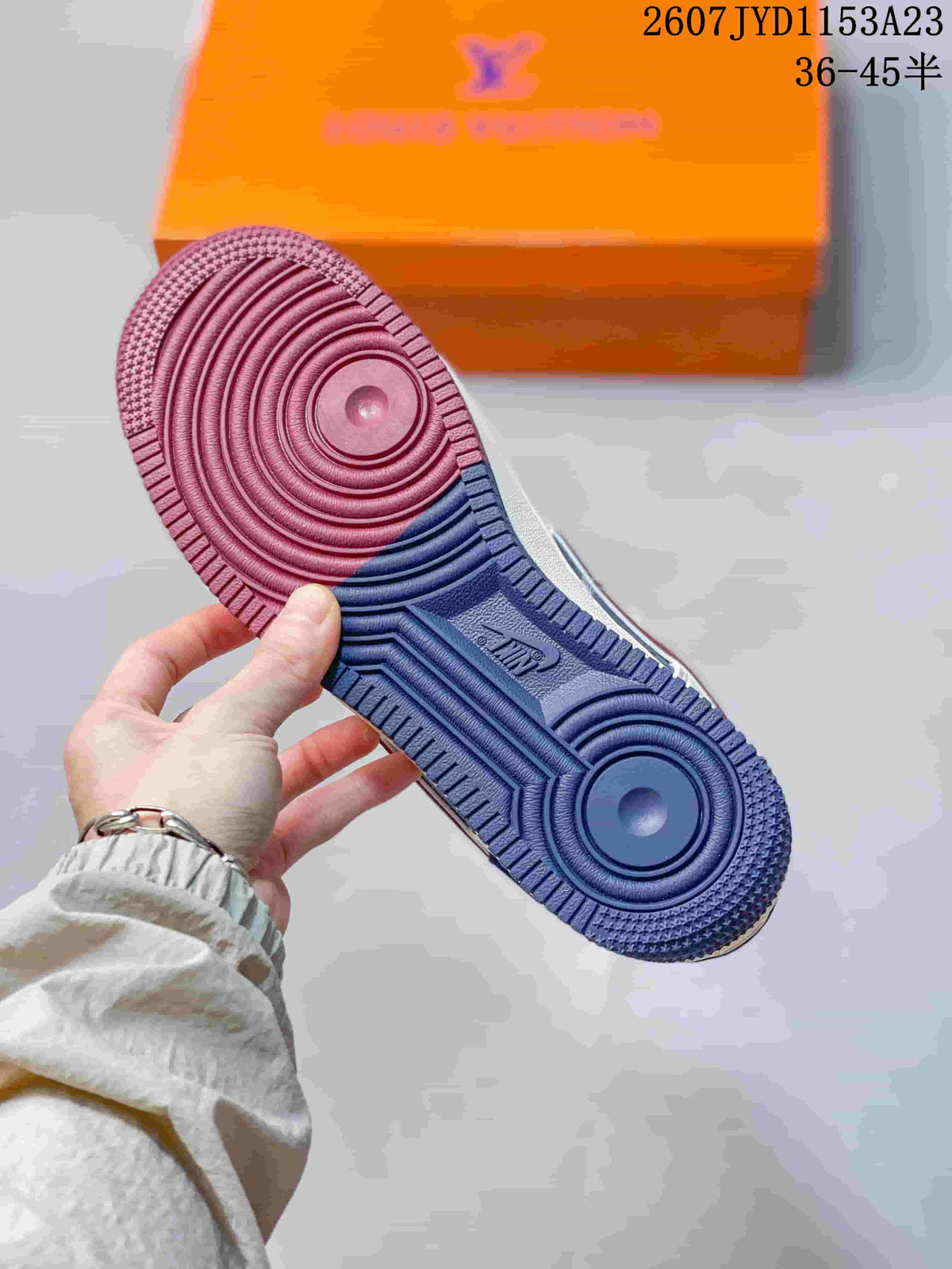 Close-up of the two-tone outsole showing circular traction grooves and Nike branding.