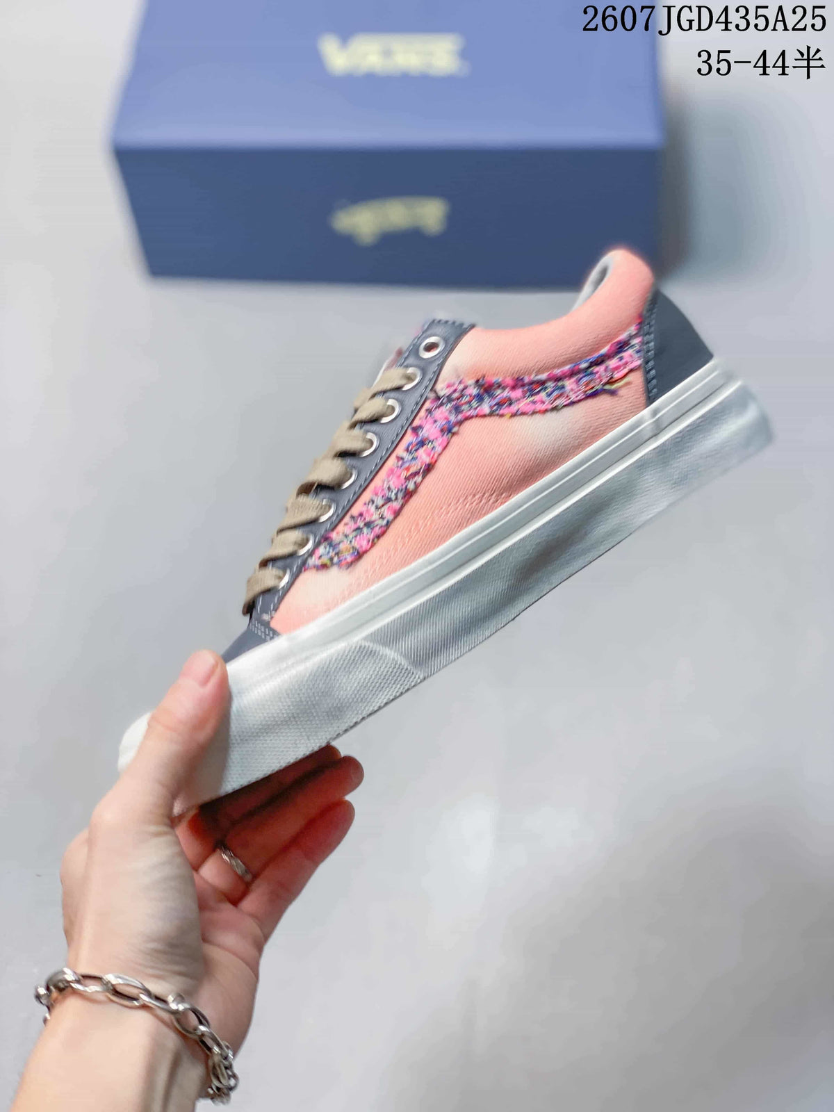 Side profile showing the pink upper, multicolor detailing, and white sole