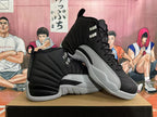 Pair of black and grey Jordan 12 high-top sneakers shown at an angle