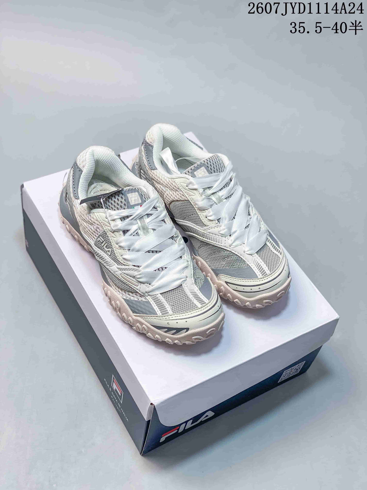 Pair of gray and white FILA Fusion sneakers displayed on a FILA shoebox.