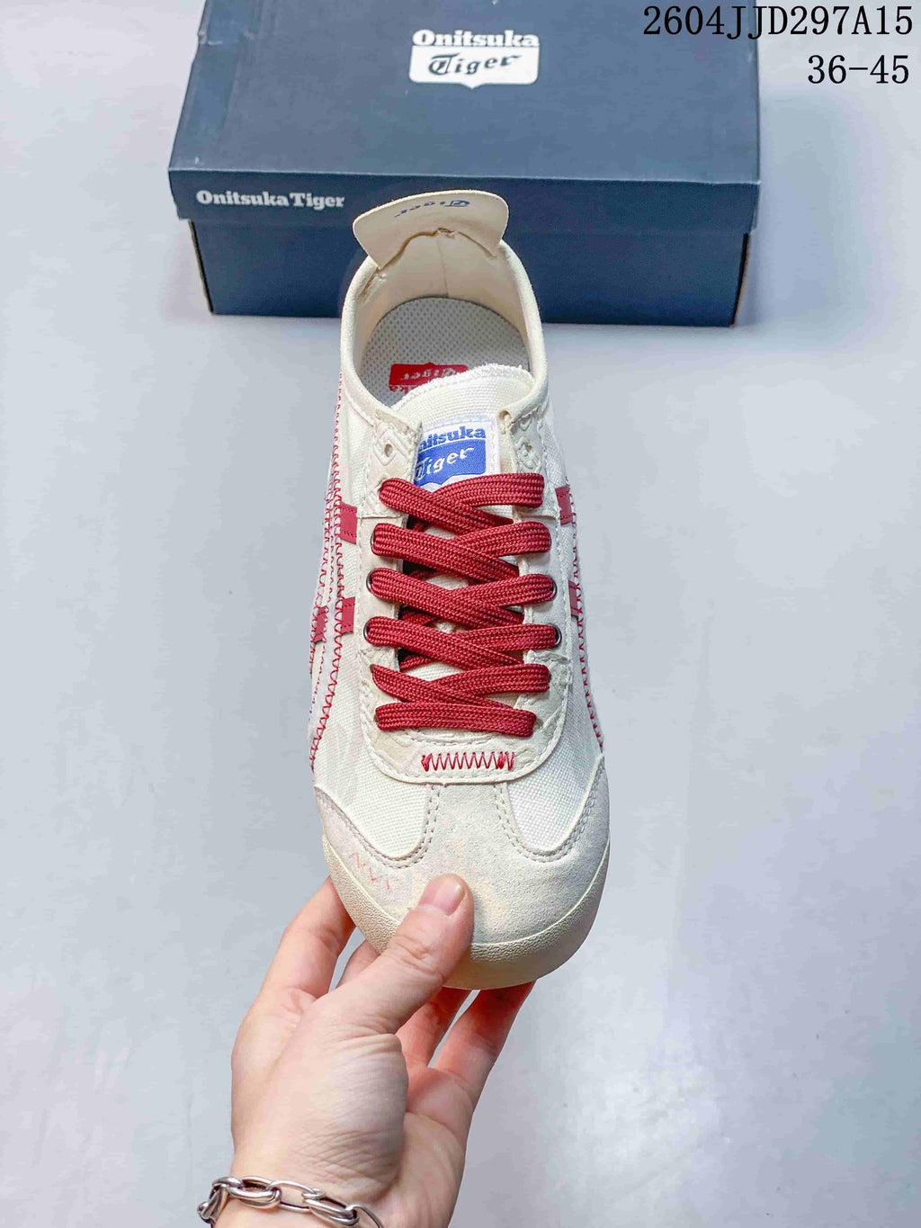 Front view showing the red laces, cream upper, and reinforced toe area