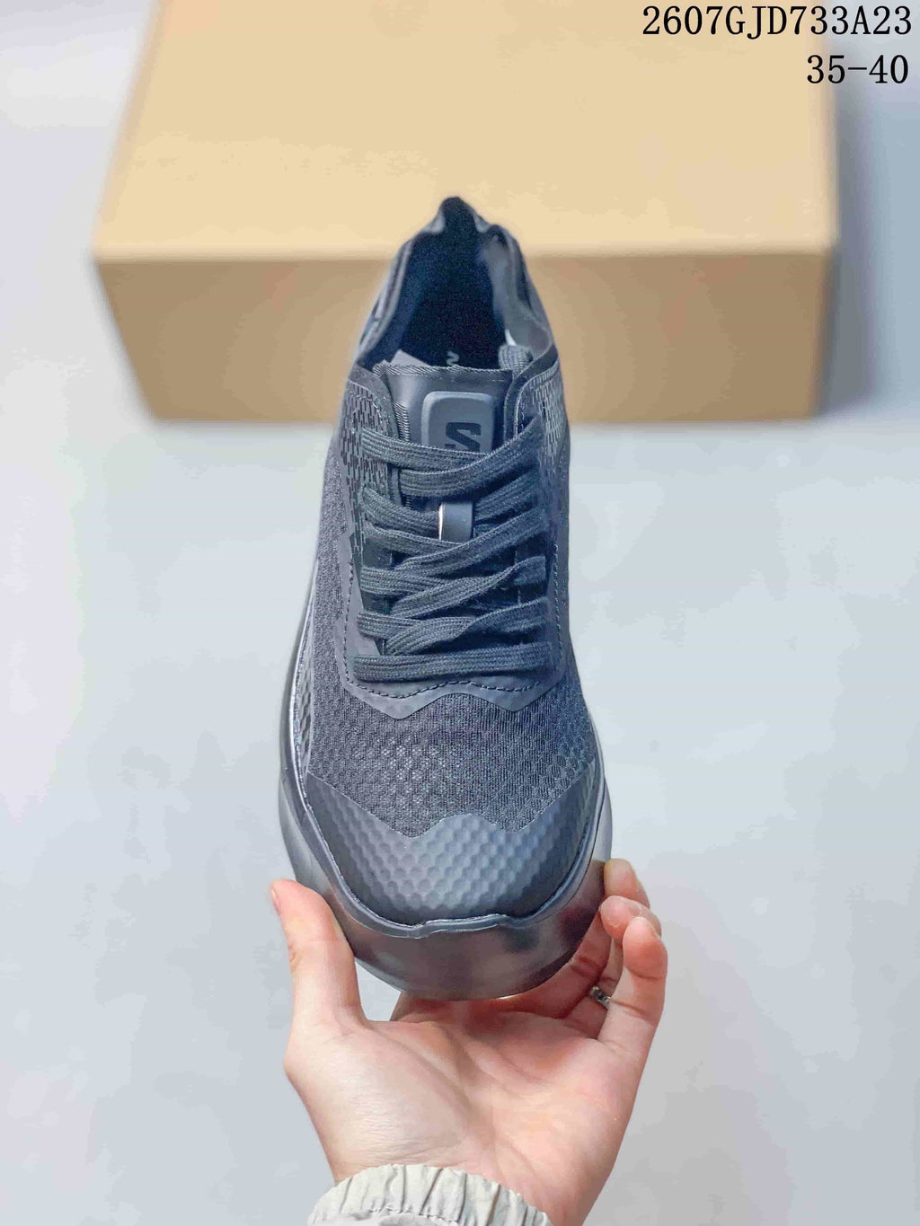 Front view showing the lace-up design, textured toe area, and dark color scheme.