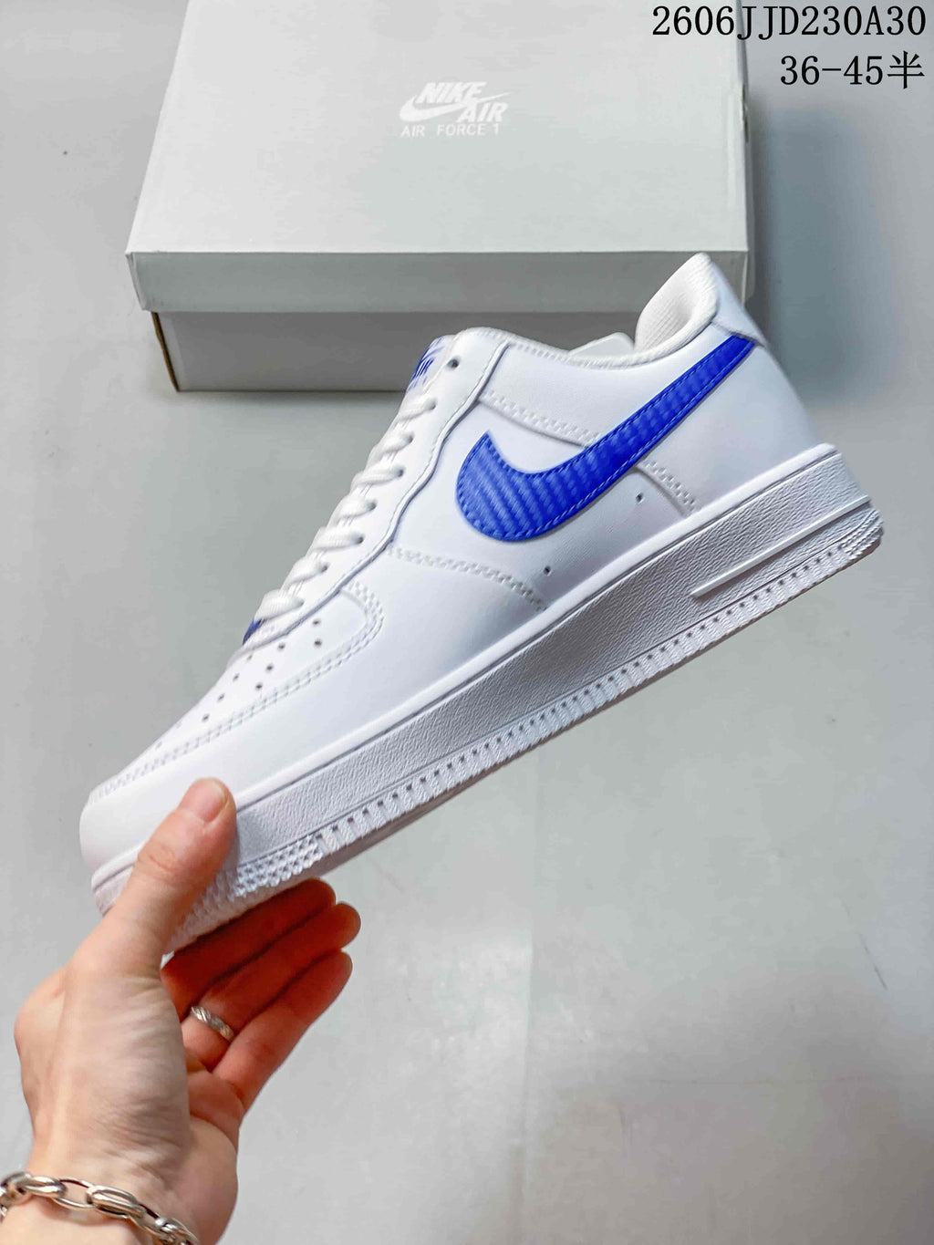 Side view of a white low-top sneaker with a blue Swoosh