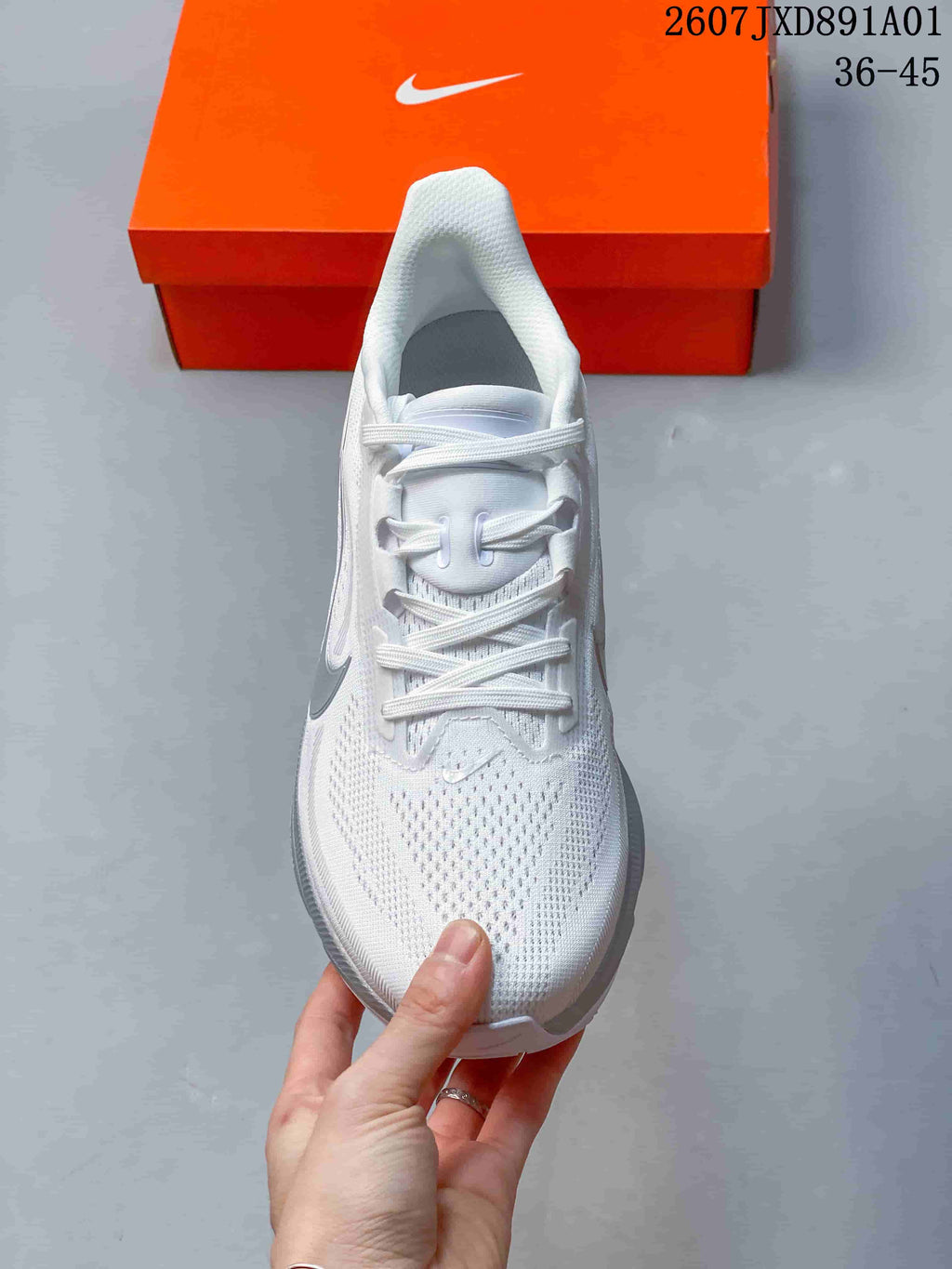 Top view of the white running shoe showing its laces and mesh-patterned upper