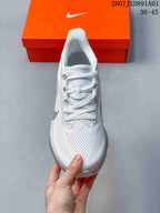 Top view of the white running shoe showing its laces and mesh-patterned upper