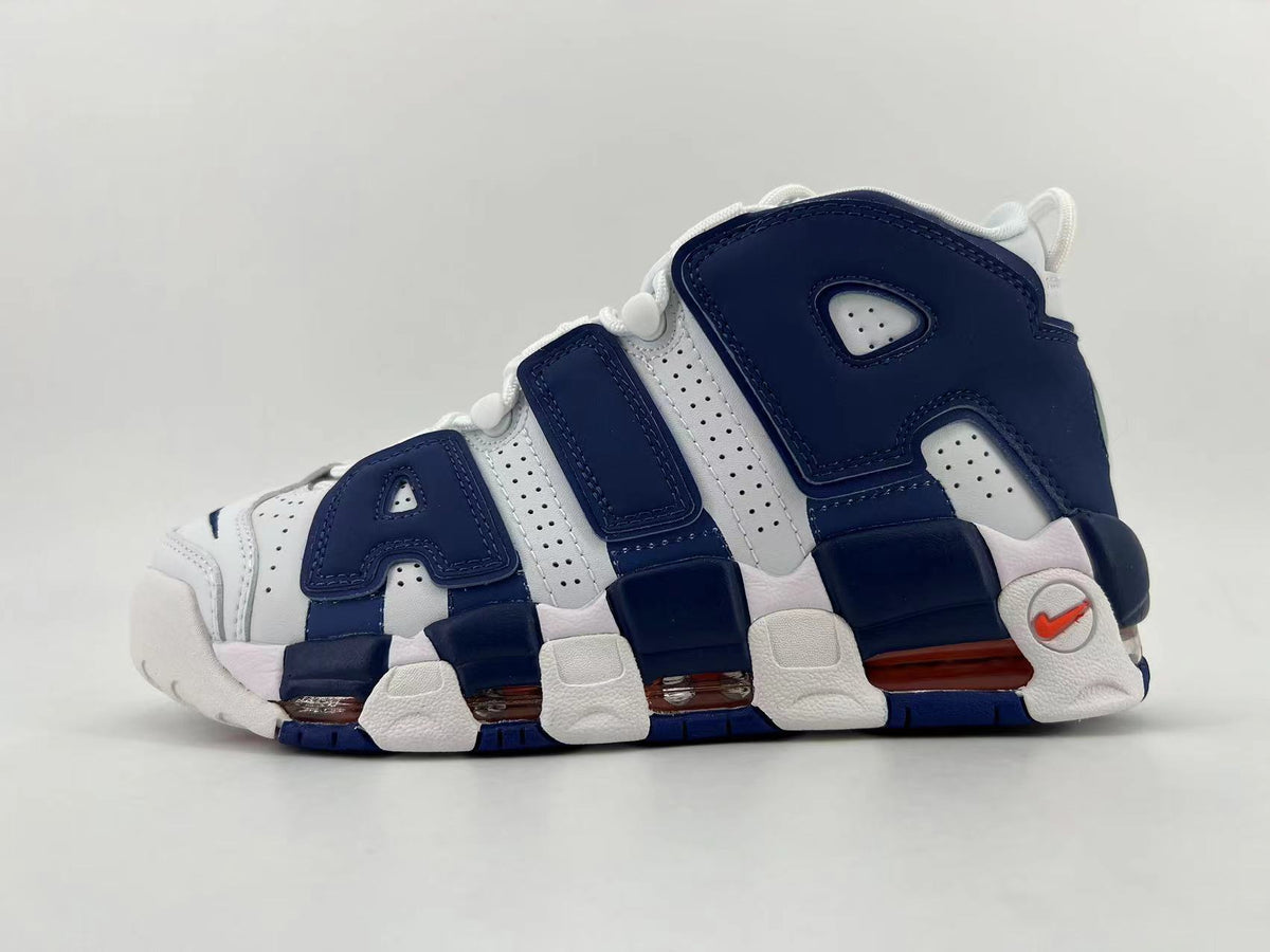Side view of white and navy Nike Air More Uptempo sneakers with oversized AIR lettering and visible cushioning windows.