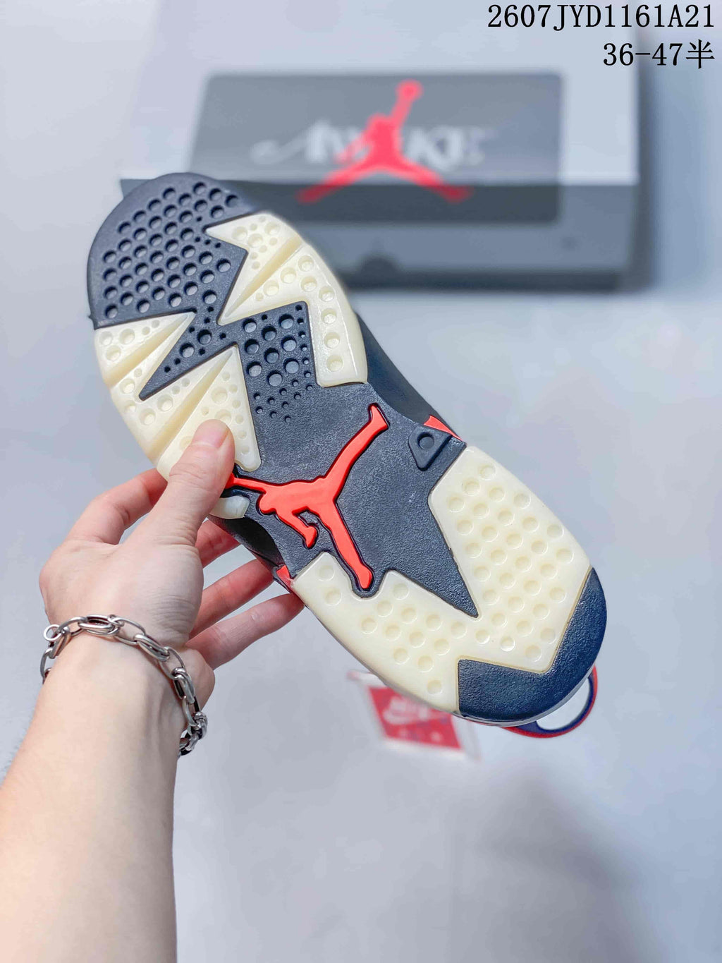 Outsole view showing the blue, black, red, and translucent tread pattern with a Jordan emblem.