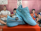 Angled view of blue Nike basketball sneakers displaying the side branding, laces, padded collars, and textured soles.