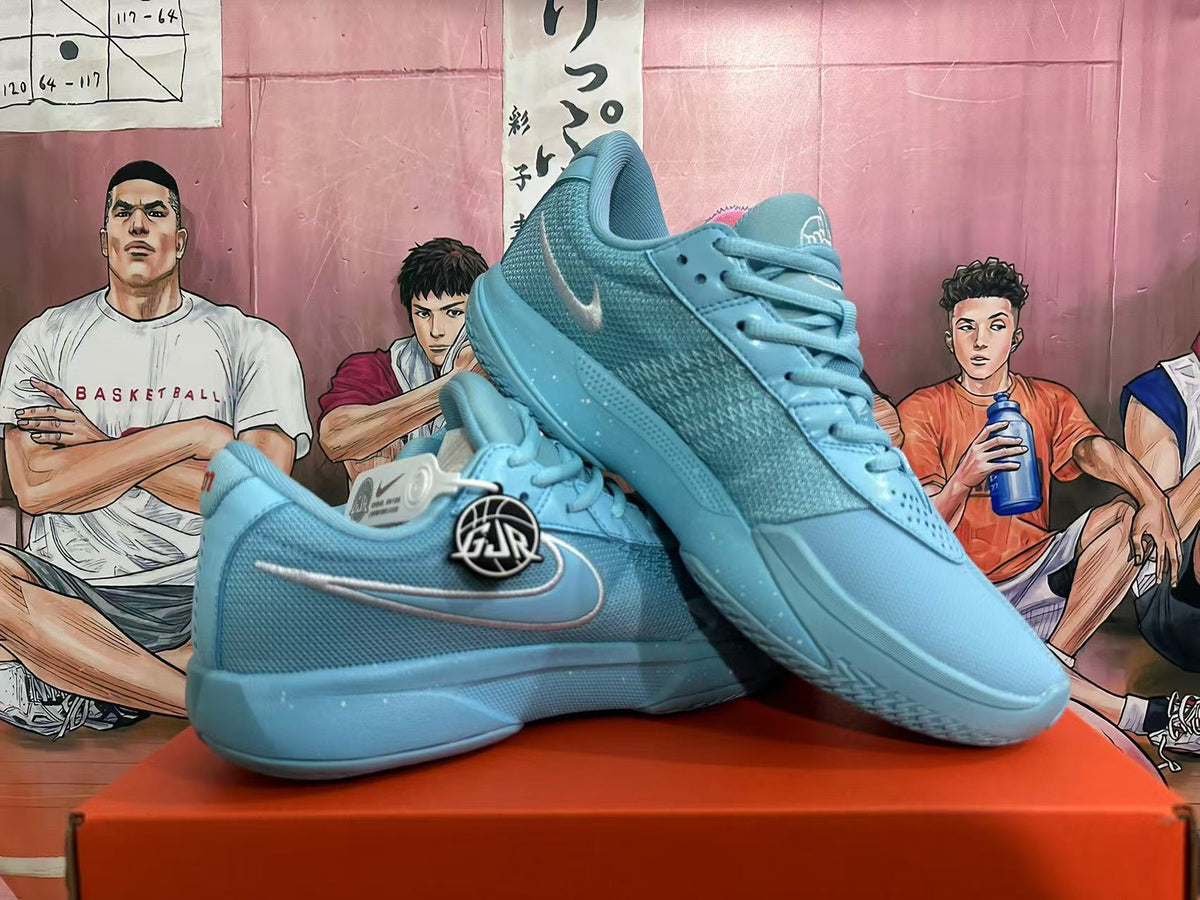 Angled view of blue Nike basketball sneakers displaying the side branding, laces, padded collars, and textured soles.