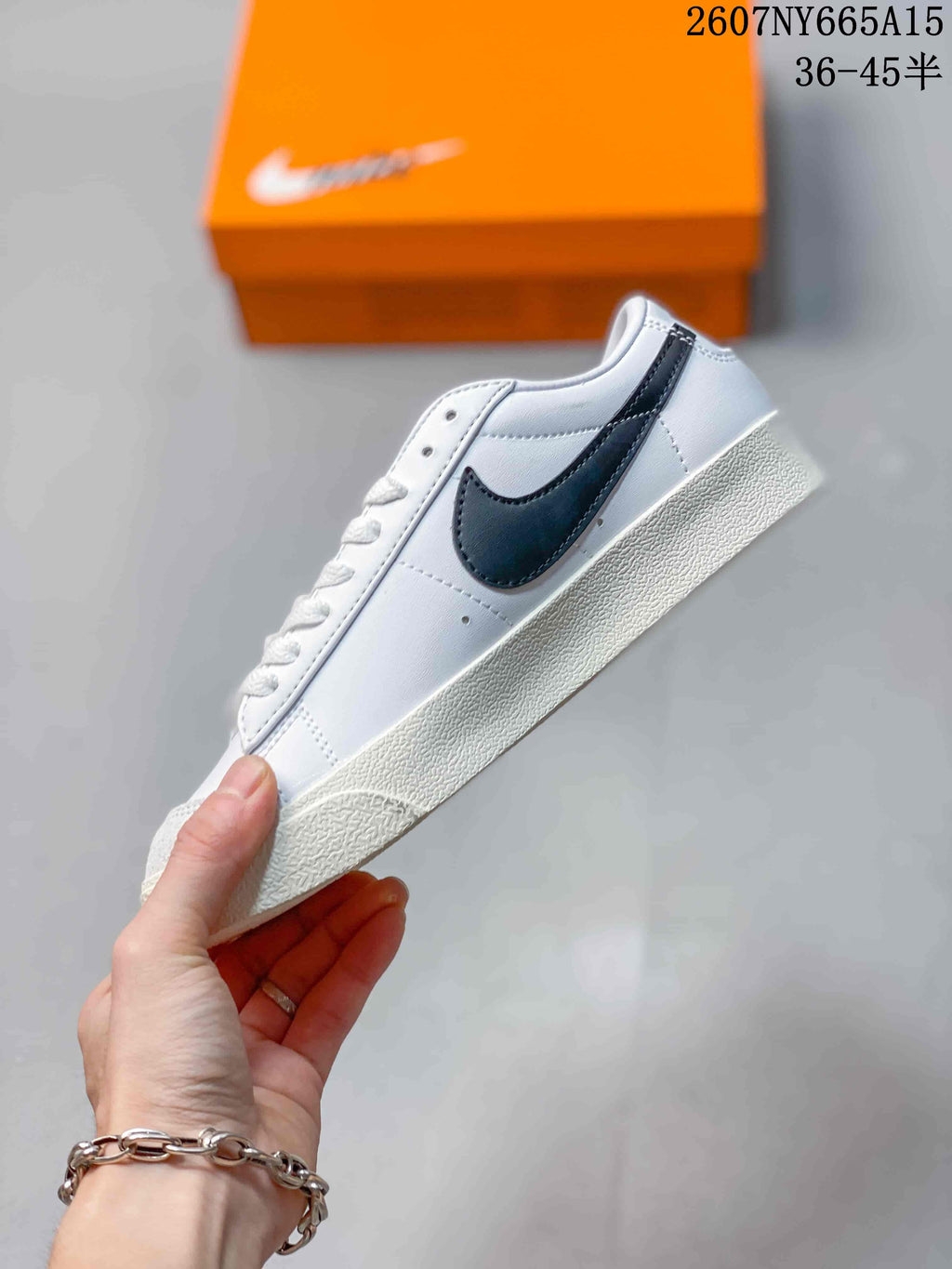 Side profile highlighting the black Swoosh, white upper and low-top silhouette.