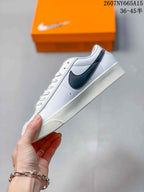 Side profile highlighting the black Swoosh, white upper and low-top silhouette.