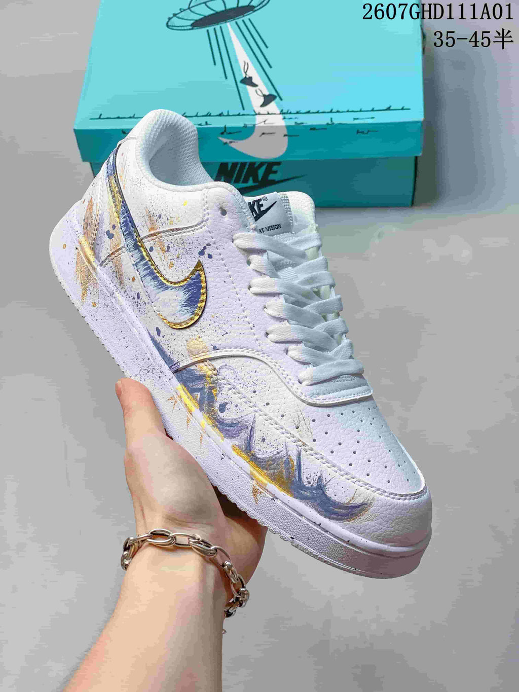 Side view of a white low-top sneaker with multicolor graphics and a contrasting swoosh