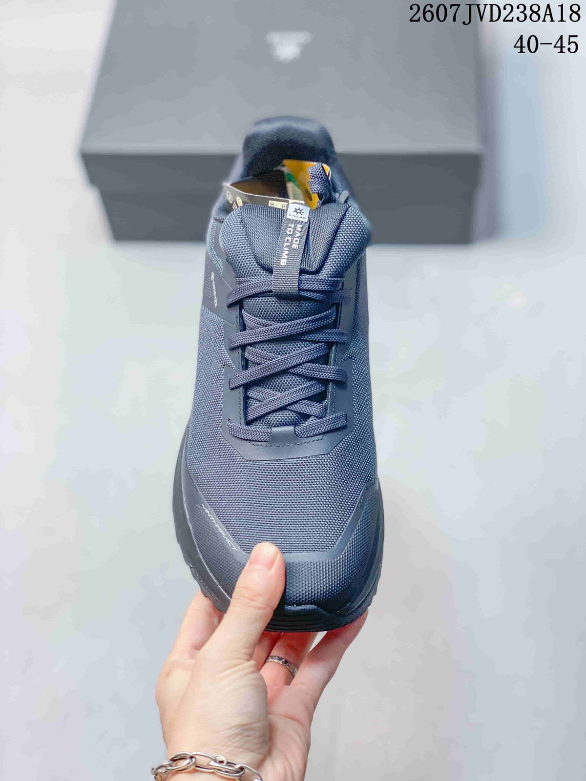 Top view of the dark gray hiking shoe showing the lace layout, padded tongue, and textured upper.
