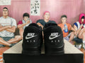 Rear view of black Nike sneakers showing contrasting Nike and AIR heel lettering.