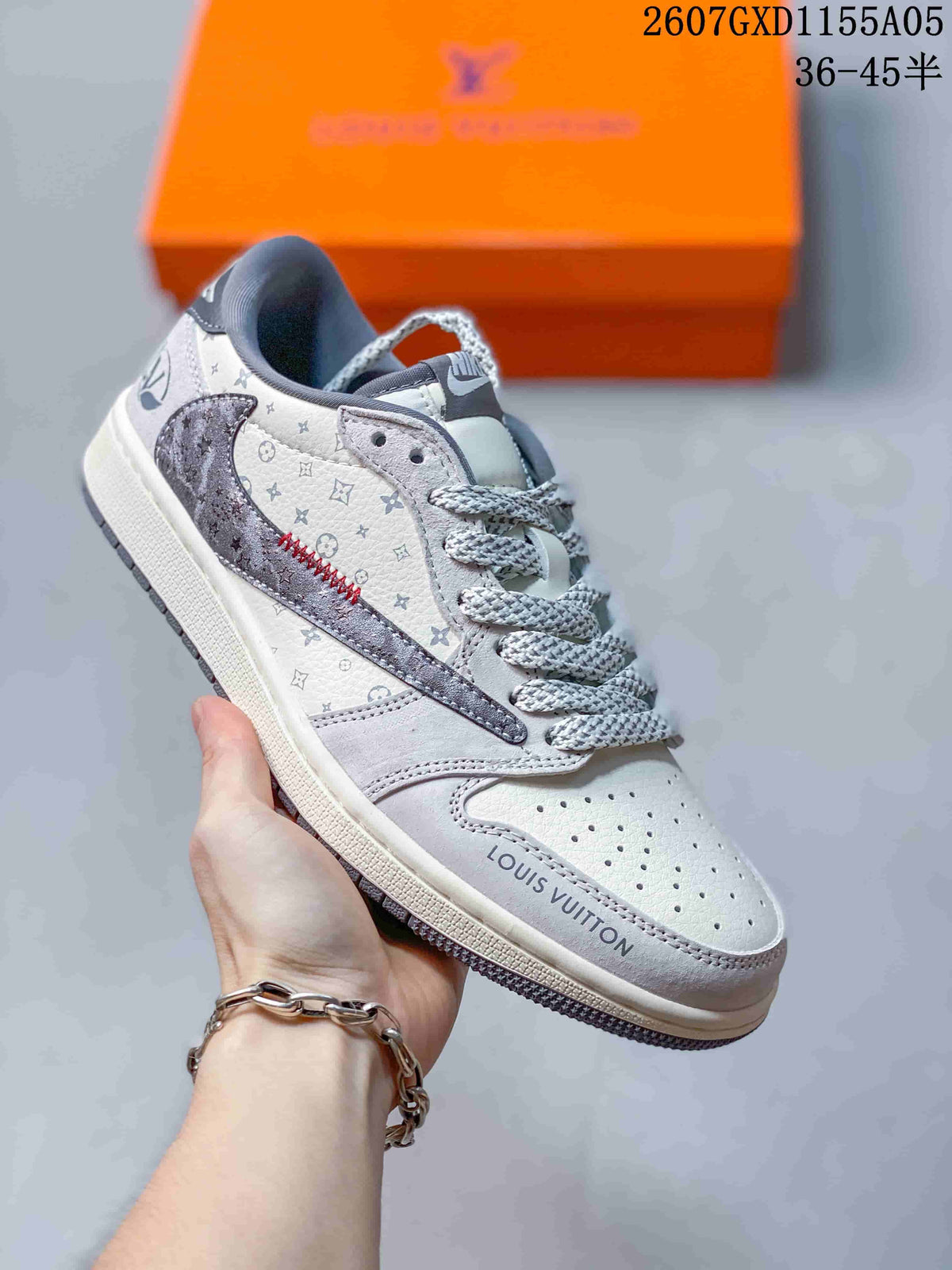 Angled side view showing the monogram-style upper, dark gray side overlay, red stitching, and printed toe detail.