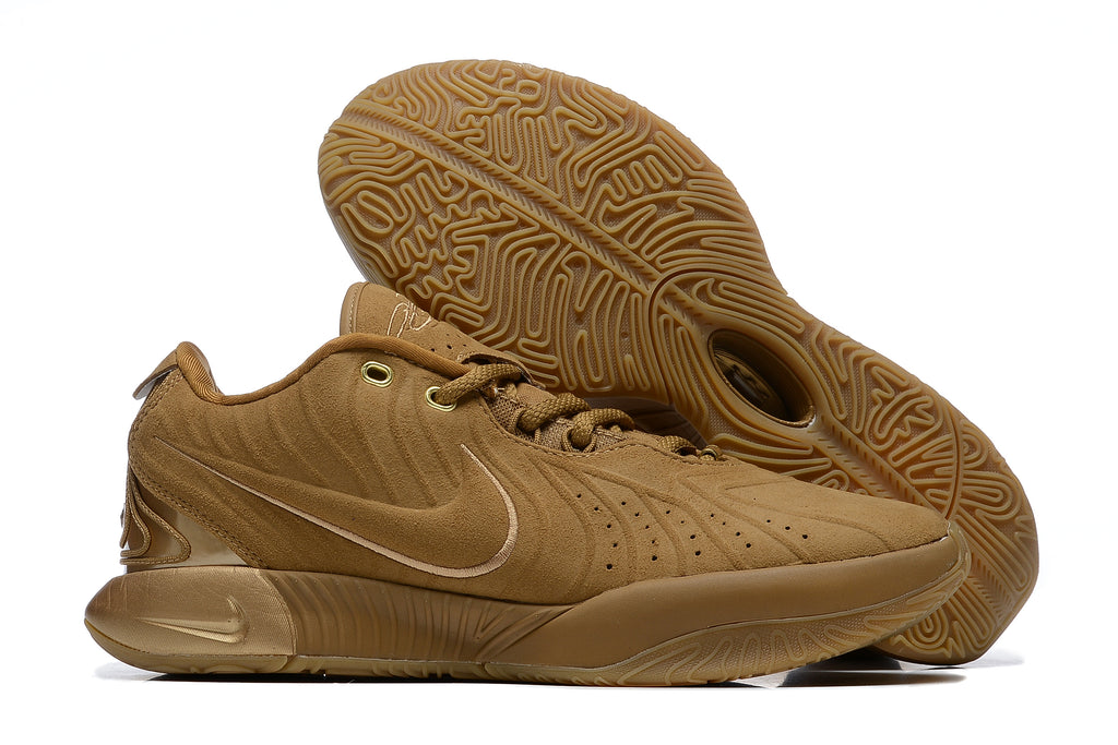 Brown Nike basketball shoes with tonal details and gum-colored outsoles.