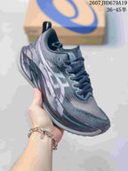 Angled side view showing the gray upper, white ASICS branding, and layered sole.