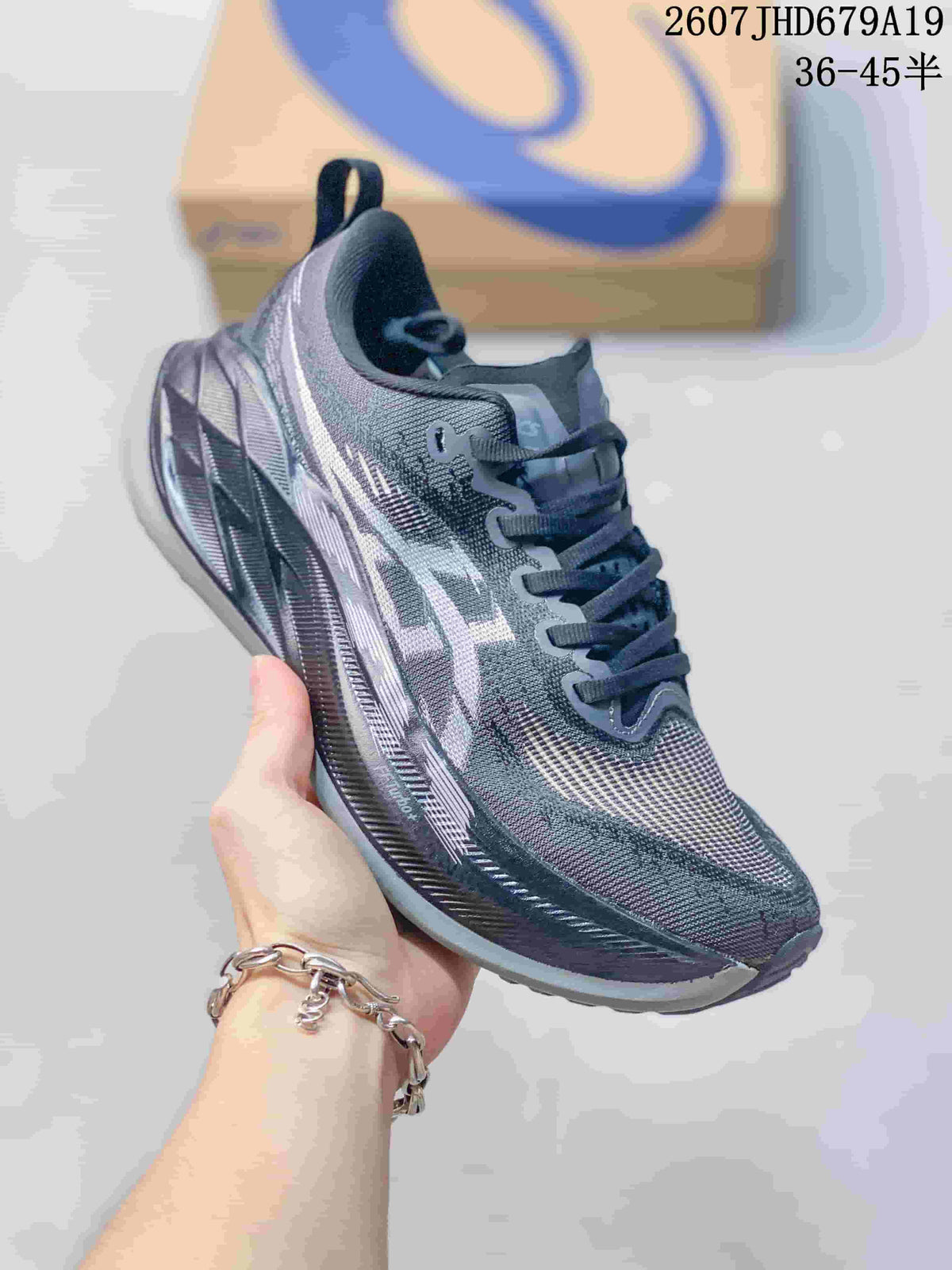 Angled side view showing the gray upper, white ASICS branding, and layered sole.