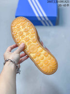 Close view of the gum-colored outsole with a repeating patterned tread.