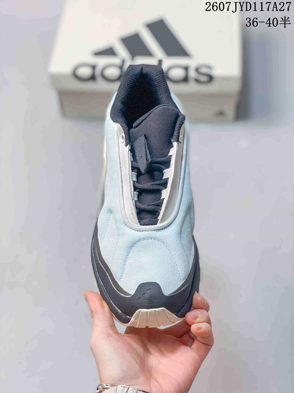 Top view of the sneaker showing the pale blue toe box, navy tongue and laces, and white lace-panel trim.