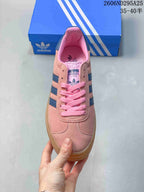 Top view showing the pink laces, rounded toe, padded collar, and tongue branding.