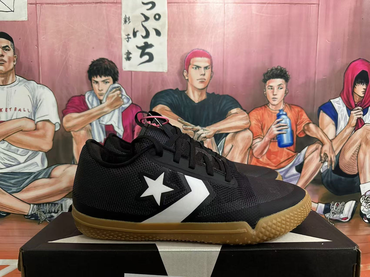 Side view showing the white star-and-chevron emblem on black sneakers
