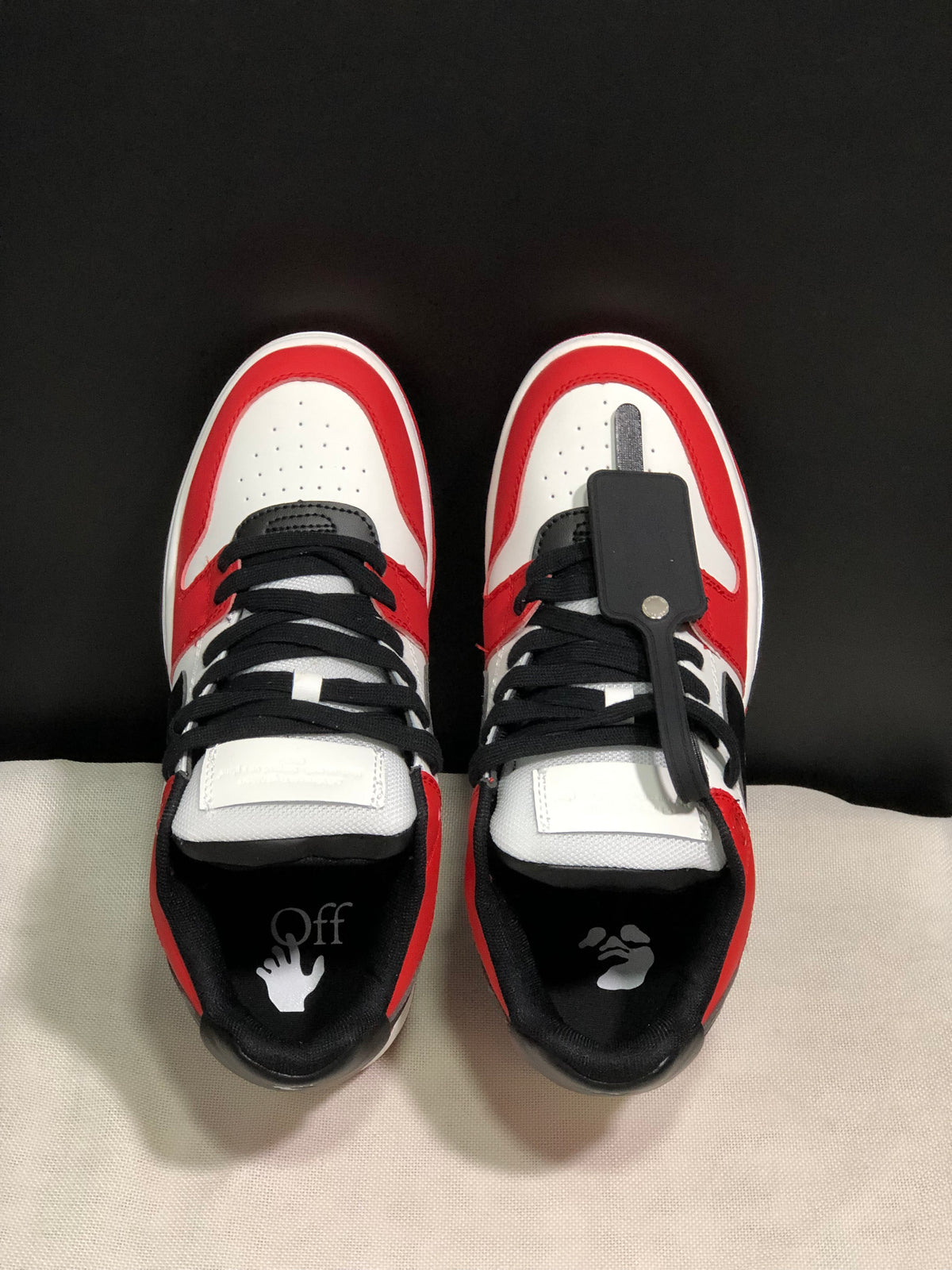 Top view showing black laces, white perforated toe boxes, padded collars, and branded insoles.