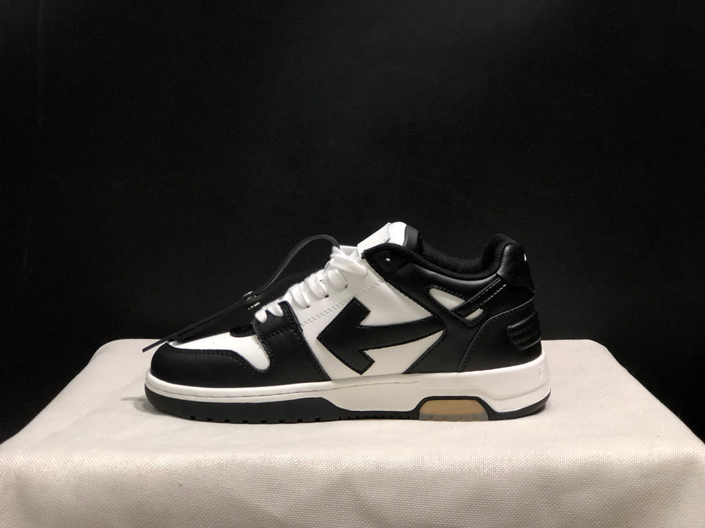 Side profile showing the low-top silhouette, contrasting arrow-style side detail, and layered outsole.