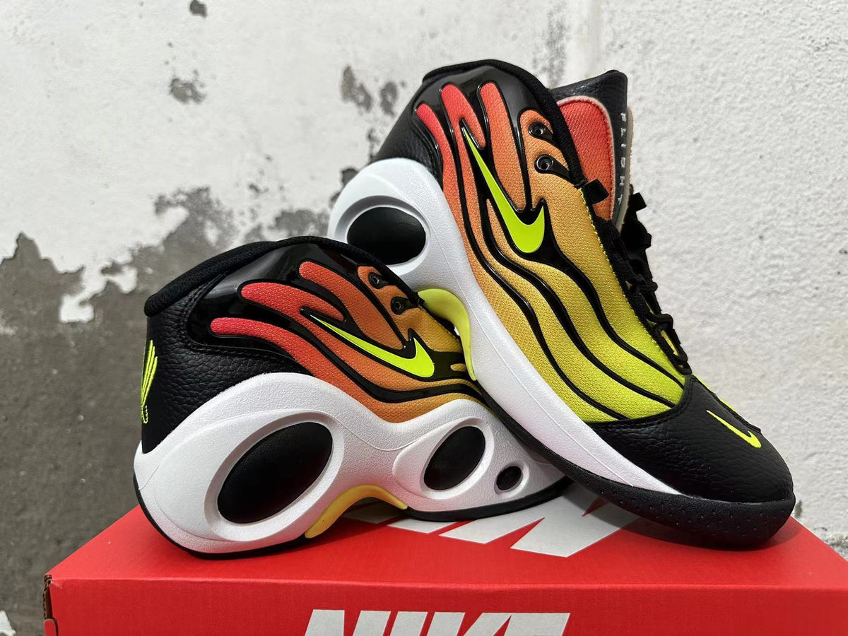 Pair of gradient yellow and orange Nike shoes displayed at an angle.
