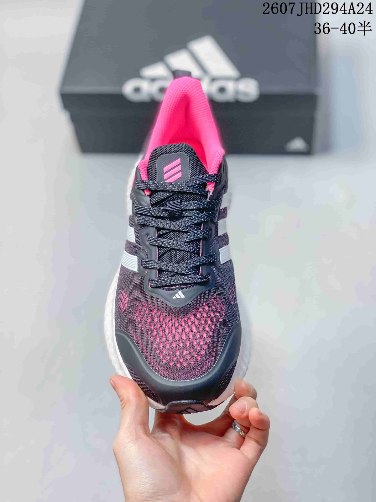 Front view showing the black lace-up upper, pink interior and patterned toe area.