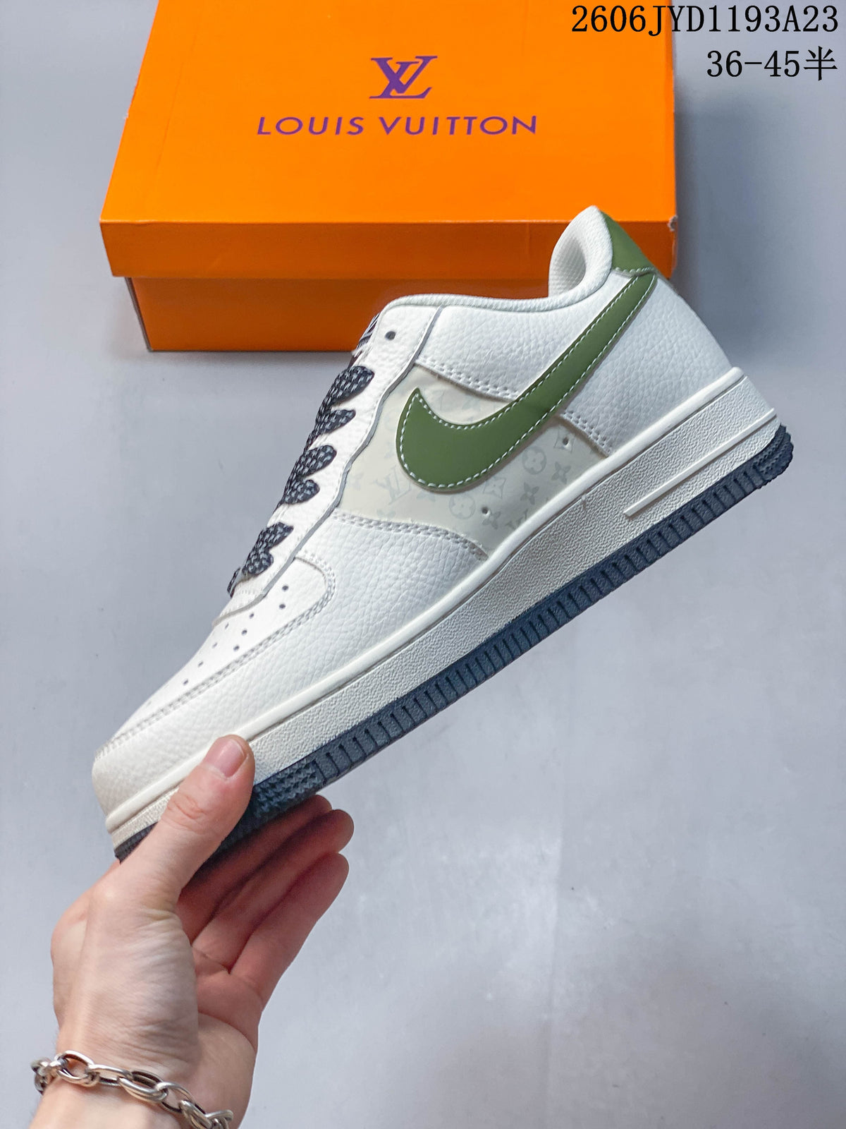 Side view of the white low-top sneaker showing green accents and patterned panels.